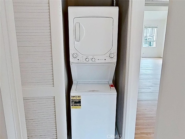 137 Corsica Dr, Newport Beach, CA 92660 - laundry room featuring stacked washer / dryer and wood finished floors
