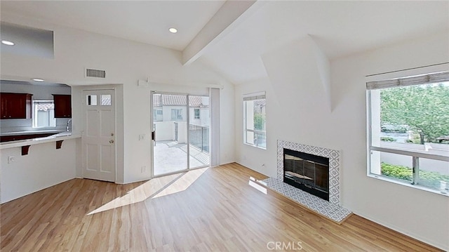 137 Corsica Dr, Newport Beach, CA 92660 - unfurnished living room featuring light wood-style flooring, a tiled fireplace, and recessed lighting