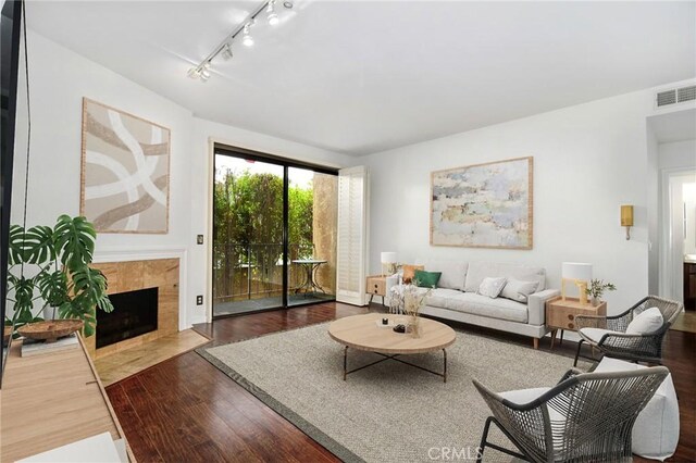 18600 Clark St Unit 102, Tarzana, CA 91356 - living area with wood finished floors, track lighting, and a fireplace