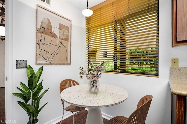 18600 Clark St Unit 102, Tarzana, CA 91356 - dining room with dark wood-style flooring and baseboards