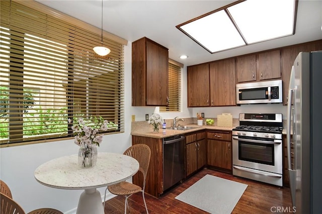 18600 Clark St Unit 102, Tarzana, CA 91356 - kitchen with stainless steel appliances, a sink, dark wood-style floors, light countertops, and recessed lighting