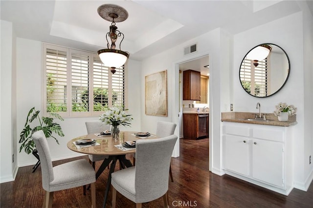 18600 Clark St Unit 102, Tarzana, CA 91356 - dining area with dark wood finished floors, wet bar, baseboards, and a tray ceiling