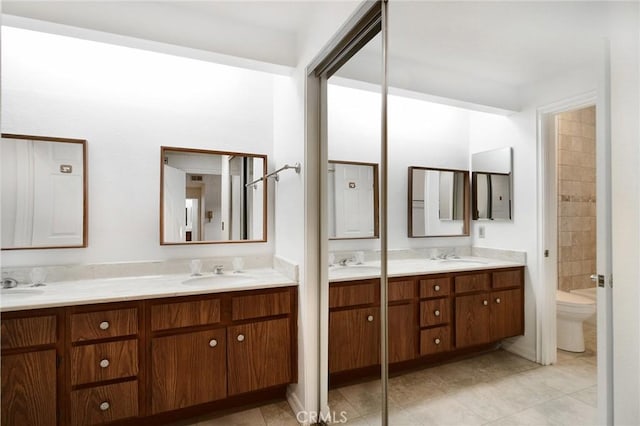 18600 Clark St Unit 102, Tarzana, CA 91356 - full bathroom featuring double vanity, tile patterned flooring, and toilet