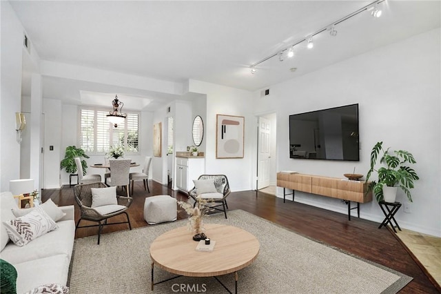 18600 Clark St Unit 102, Tarzana, CA 91356 - living area with wood finished floors, a chandelier, rail lighting, and baseboards