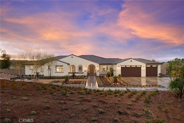 16402 Ginger Creek Dr, Riverside, CA 92504 - mediterranean / spanish house with a garage, driveway, stucco siding, and a tiled roof