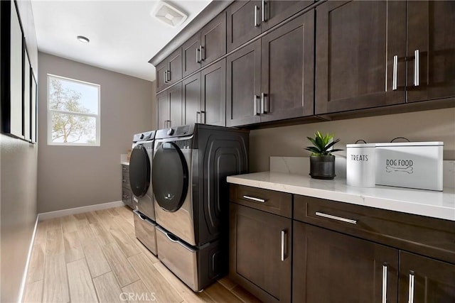 16402 Ginger Creek Dr, Riverside, CA 92504 - washroom with cabinet space, independent washer and dryer, and light wood-type flooring