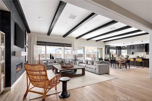 16402 Ginger Creek Dr, Riverside, CA 92504 - living area with beam ceiling, light wood finished floors, and a large fireplace