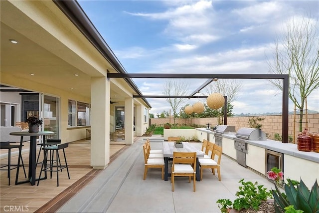 16402 Ginger Creek Dr, Riverside, CA 92504 - view of patio featuring area for grilling, outdoor dining area, a ceiling fan, and wine cooler