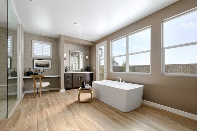 16402 Ginger Creek Dr, Riverside, CA 92504 - bathroom featuring a soaking tub, vanity, and wood finished floors