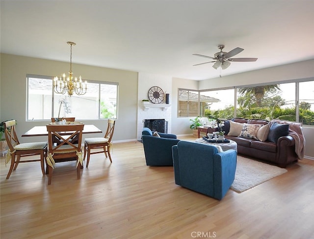 1621 Espinosa Cir, Palos Verdes Estates, CA 90274 - living room with light wood-type flooring, a fireplace, ceiling fan, baseboards, and a chandelier