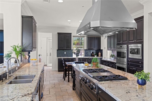 15020 Applewood Ct, San Diego, CA 92131 - kitchen with island exhaust hood, a sink, stainless steel appliances, stone tile flooring, and crown molding