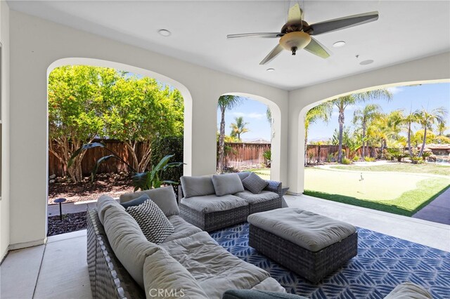 15020 Applewood Ct, San Diego, CA 92131 - fenced backyard with outdoor lounge area, an area to practice putting, a patio area, and a ceiling fan