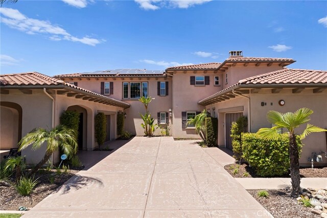 15020 Applewood Ct, San Diego, CA 92131 - mediterranean / spanish house featuring driveway, a garage, solar panels, and stucco siding