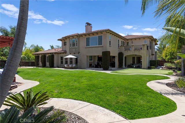 15020 Applewood Ct, San Diego, CA 92131 - rear view of property featuring a chimney, stucco siding, a putting area, and a balcony