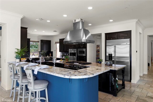 15020 Applewood Ct, San Diego, CA 92131 - kitchen featuring stainless steel appliances, island range hood, a kitchen bar, crown molding, and light stone countertops