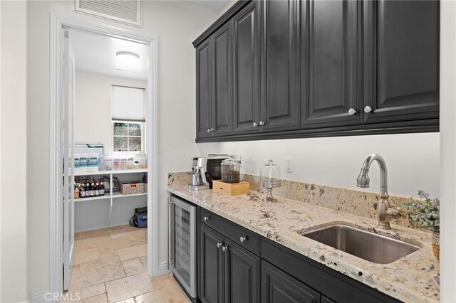 15020 Applewood Ct, San Diego, CA 92131 - kitchen with wine cooler, a sink, dark cabinets, and stone tile floors