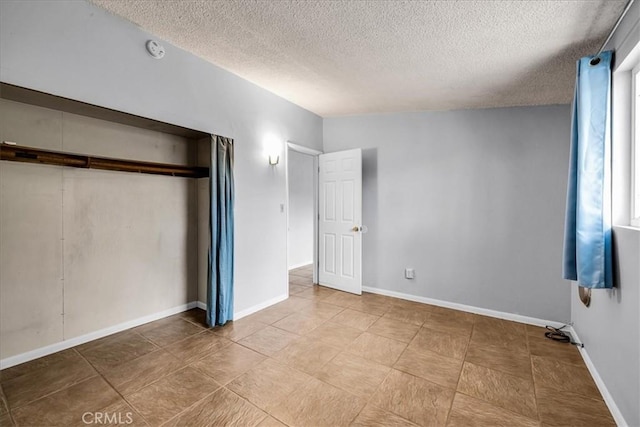5799 Halsey Ave Unit 29, Palms, CA 92277 - unfurnished bedroom with a textured ceiling, a closet, and baseboards