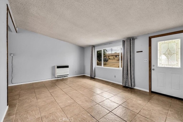 5799 Halsey Ave Unit 29, Palms, CA 92277 - entryway with heating unit, a textured ceiling, light tile patterned floors, and baseboards