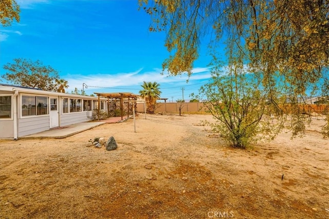 5799 Halsey Ave Unit 29, Palms, CA 92277 - fenced backyard with a sunroom and a patio