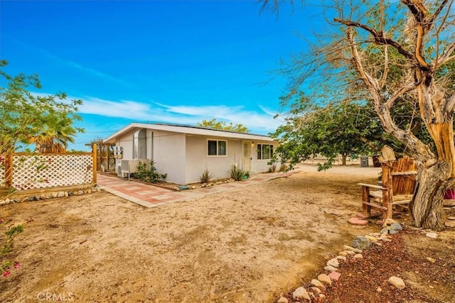 5799 Halsey Ave Unit 29, Palms, CA 92277 - view of side of property with fence, stucco siding, and a patio area