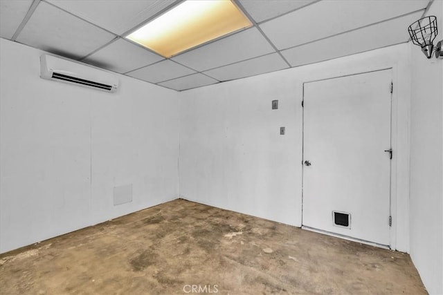 5799 Halsey Ave Unit 29, Palms, CA 92277 - empty room featuring a wall mounted AC, concrete flooring, and a paneled ceiling