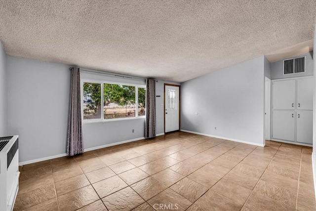 5799 Halsey Ave Unit 29, Palms, CA 92277 - unfurnished room featuring a textured ceiling, baseboards, and light tile patterned floors