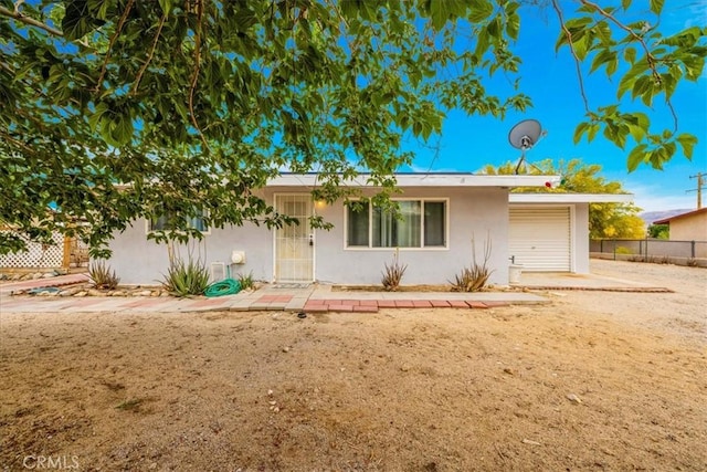 5799 Halsey Ave Unit 29, Palms, CA 92277 - ranch-style house featuring stucco siding, a garage, and fence