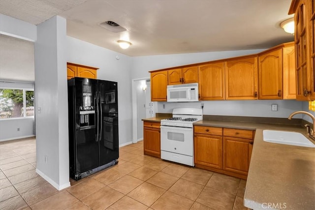 5799 Halsey Ave Unit 29, Palms, CA 92277 - kitchen featuring white appliances, a sink, light tile patterned floors, brown cabinetry, and lofted ceiling