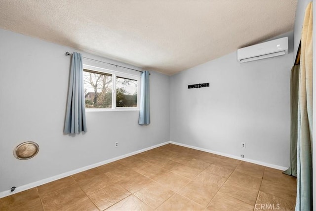 5799 Halsey Ave Unit 29, Palms, CA 92277 - unfurnished room with a wall unit AC, a textured ceiling, baseboards, and light tile patterned floors