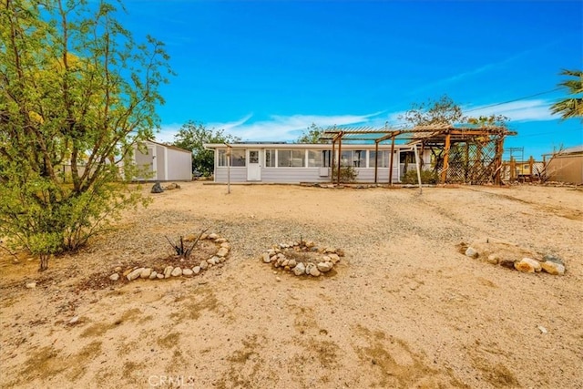 5799 Halsey Ave Unit 29, Palms, CA 92277 - rear view of house with a pergola
