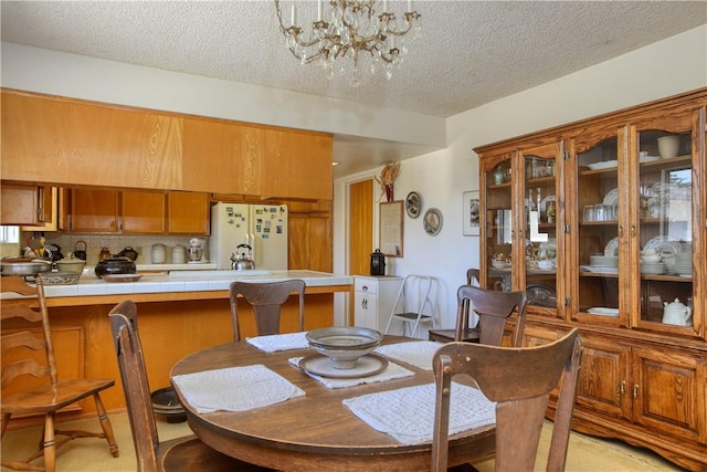 2661 Southview Ave, Arroyo Grande, CA 93420 - dining area with a textured ceiling and a chandelier