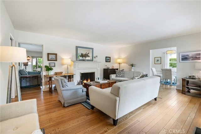 1981 Sinaloa Ave, Altadena, CA 91001 - living room featuring a lit fireplace and light wood finished floors