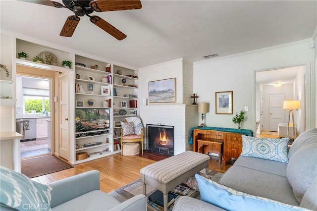 1981 Sinaloa Ave, Altadena, CA 91001 - living room with ceiling fan, a brick fireplace, light wood-type flooring, crown molding, and built in features