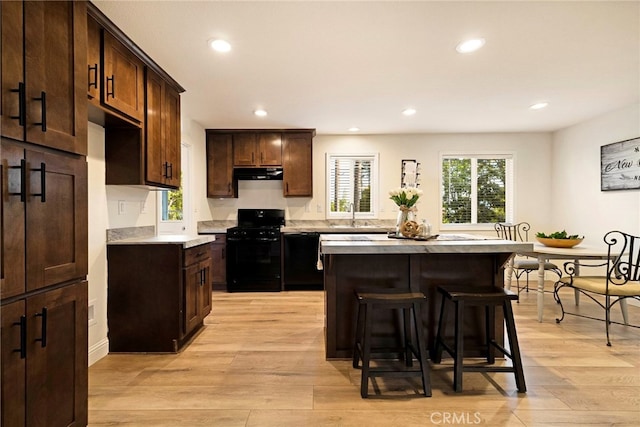 1612 San Jose Ln, Paradise, CA 95969 - kitchen featuring black appliances, under cabinet range hood, recessed lighting, light countertops, and a breakfast bar