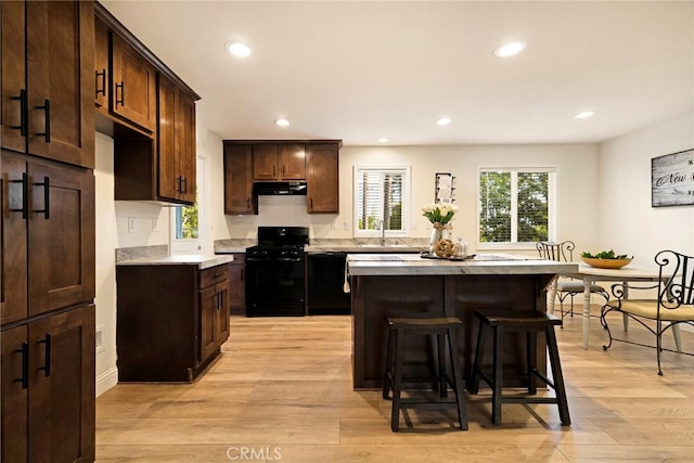 1612 San Jose Ln, Paradise, CA 95969 - kitchen featuring black appliances, under cabinet range hood, recessed lighting, light countertops, and a breakfast bar