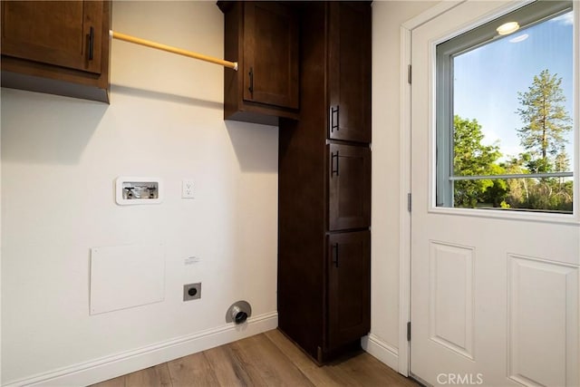 1612 San Jose Ln, Paradise, CA 95969 - laundry room featuring cabinet space, hookup for an electric dryer, hookup for a washing machine, light wood-style floors, and baseboards