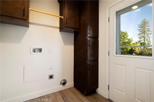 1612 San Jose Ln, Paradise, CA 95969 - laundry area with cabinet space, hookup for an electric dryer, washer hookup, light wood finished floors, and baseboards