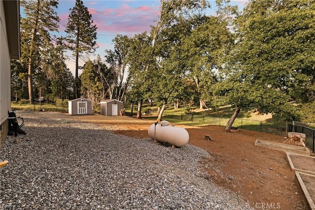 1612 San Jose Ln, Paradise, CA 95969 - view of yard with a storage unit, an outdoor structure, fence, and view of scattered trees