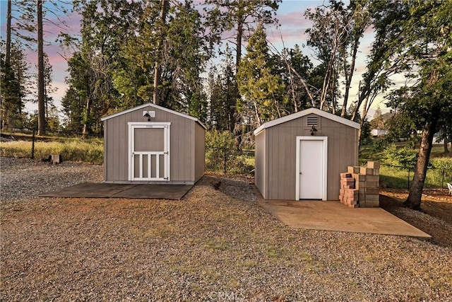 1612 San Jose Ln, Paradise, CA 95969 - outdoor structure at dusk featuring a storage unit and a fenced backyard