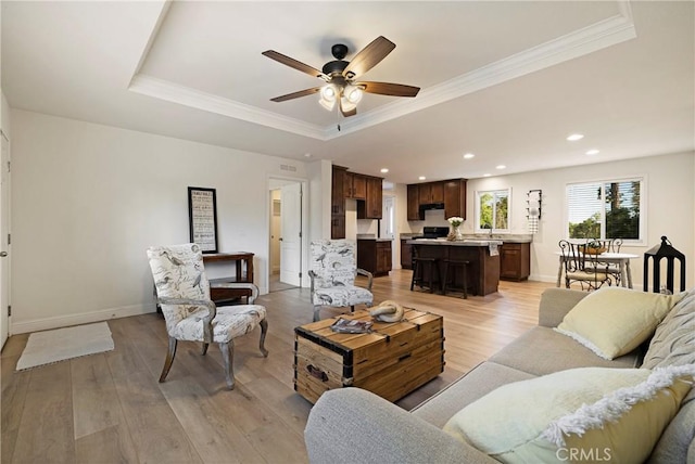 1612 San Jose Ln, Paradise, CA 95969 - living area featuring crown molding, a raised ceiling, ceiling fan, light wood-type flooring, and baseboards