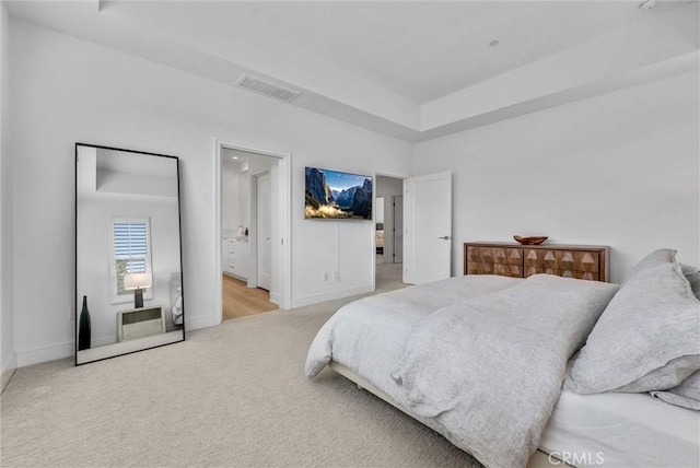 107 Plum Lily, Irvine, CA 92618 - carpeted bedroom featuring baseboards, a tray ceiling, and ensuite bath