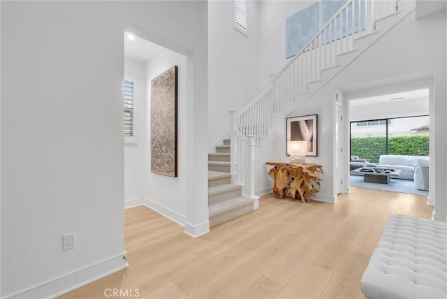 107 Plum Lily, Irvine, CA 92618 - foyer with stairway, wood finished floors, baseboards, and a high ceiling