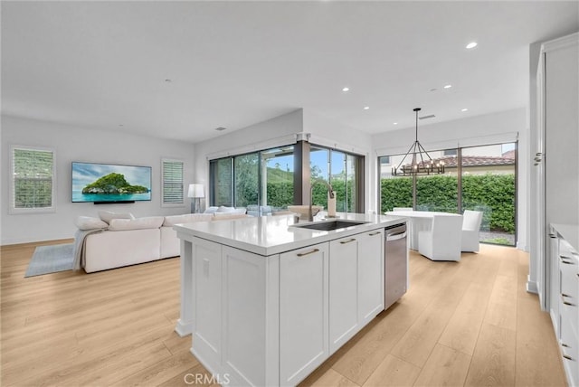 107 Plum Lily, Irvine, CA 92618 - kitchen featuring a sink, white cabinetry, healthy amount of natural light, light countertops, and recessed lighting