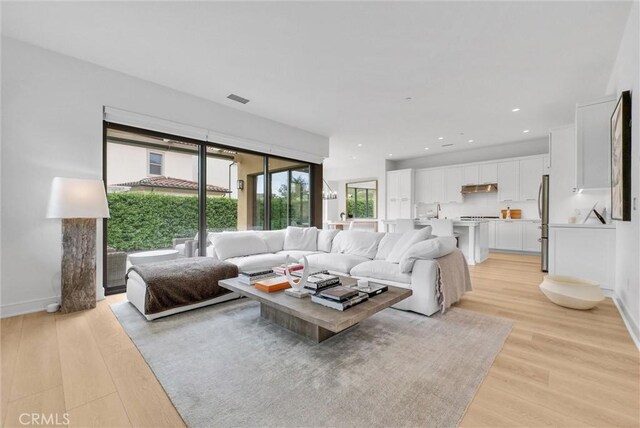 107 Plum Lily, Irvine, CA 92618 - living room with light wood-style flooring and baseboards