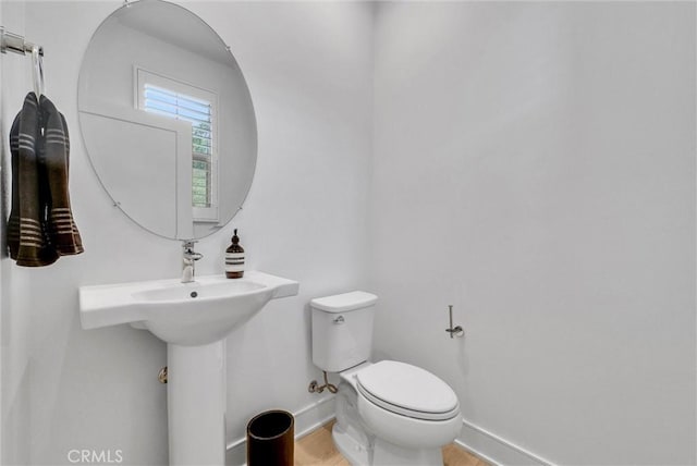 107 Plum Lily, Irvine, CA 92618 - half bath with baseboards, toilet, and wood finished floors