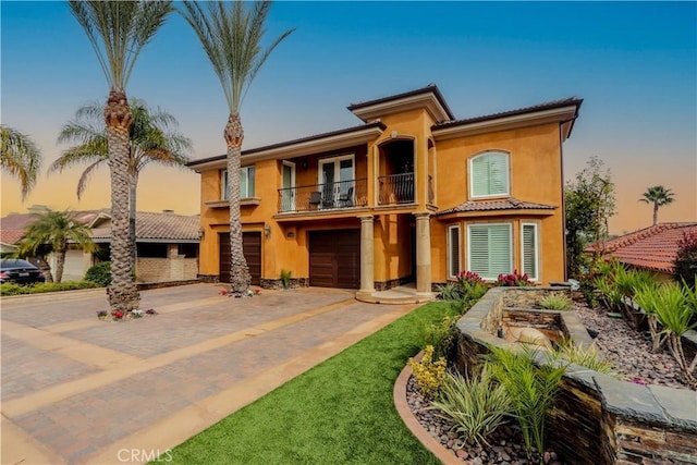 23180 Gray Fox Dr, Canyon Lake, CA 92587 - mediterranean / spanish-style house with a balcony, driveway, a garage, stucco siding, and a tiled roof
