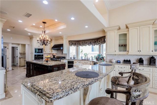 23180 Gray Fox Dr, Canyon Lake, CA 92587 - kitchen featuring crown molding, a kitchen island, black microwave, oven, and under cabinet range hood