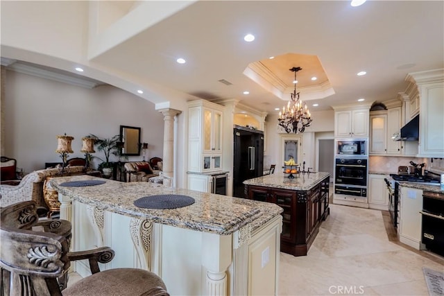 23180 Gray Fox Dr, Canyon Lake, CA 92587 - kitchen featuring black appliances, beverage cooler, under cabinet range hood, a center island, and ornamental molding