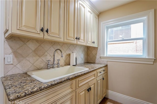 23180 Gray Fox Dr, Canyon Lake, CA 92587 - kitchen featuring a sink, backsplash, cream cabinetry, and light stone countertops