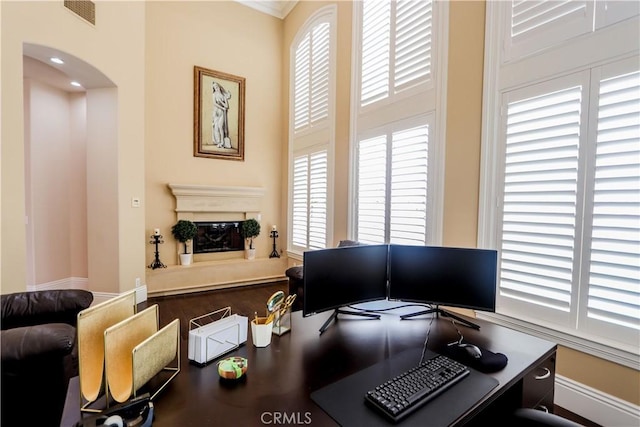 23180 Gray Fox Dr, Canyon Lake, CA 92587 - office area with arched walkways, plenty of natural light, and a glass covered fireplace